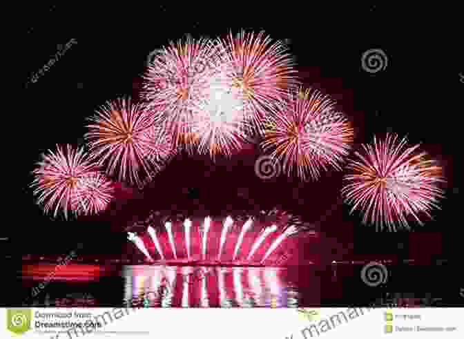 Fireworks Bursting Over The Rooftops Of Sainte Marie La Mer, Casting A Vibrant Glow On The Town Below. Fireworks In France (A Reverend Annabelle Dixon Mystery 7)