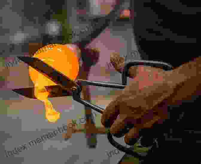 Image Of A Person Using A Pointed Flame To Shape Molten Glass Into A Heart Shape. How To Make A Heart Lampwork Bead